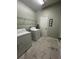Functional laundry room with washer, dryer, shelving, and stylish tiled floors at 8894 Candy Palm Rd, Kissimmee, FL 34747
