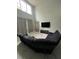 Bright living room with a soaring ceiling, modern lighting, plush sectional sofa, and large windows for natural light at 8894 Candy Palm Rd, Kissimmee, FL 34747