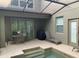 Covered patio with outdoor seating, grill, and access to a refreshing pool area at 8894 Candy Palm Rd, Kissimmee, FL 34747
