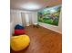 Spacious playroom with colorful beanbags and a mural at 8894 Candy Palm Rd, Kissimmee, FL 34747