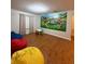 Spacious playroom with colorful beanbags and a mural at 8894 Candy Palm Rd, Kissimmee, FL 34747