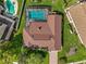 Aerial view of a home with a pool, well-maintained roof, and brick driveway at 9326 Bay Vista Estates Blvd, Orlando, FL 32836