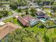 Aerial view of a home with a screened pool, well-manicured lawn, and mature landscaping at 9326 Bay Vista Estates Blvd, Orlando, FL 32836