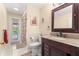 Bathroom featuring granite countertops, sleek vanity, and access to the backyard pool at 9326 Bay Vista Estates Blvd, Orlando, FL 32836