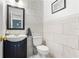 Stylish half-bathroom featuring a modern vanity and tile backsplash at 9326 Bay Vista Estates Blvd, Orlando, FL 32836