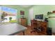 Bright bedroom featuring a large window, wood floors, and traditional wooden desk at 9326 Bay Vista Estates Blvd, Orlando, FL 32836