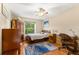Cozy bedroom with a ceiling fan, hardwood floors, and a comfortable-looking bed at 9326 Bay Vista Estates Blvd, Orlando, FL 32836