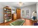 Bedroom featuring a bookcase, wooden floors, and a view of the outdoors through glass doors at 9326 Bay Vista Estates Blvd, Orlando, FL 32836