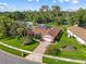 Inviting single-story home with lush landscaping, brick accents, and a neatly paved driveway at 9326 Bay Vista Estates Blvd, Orlando, FL 32836