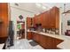 Spacious kitchen features wooden cabinetry, mosaic backsplash, stainless appliances, and white marbled tile floor at 9326 Bay Vista Estates Blvd, Orlando, FL 32836