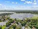 Panoramic aerial view of a lakefront community with beautiful homes and lush greenery at 9326 Bay Vista Estates Blvd, Orlando, FL 32836