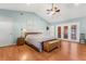 Spacious main bedroom with wood floors, tray ceiling, and doors to the lanai at 9326 Bay Vista Estates Blvd, Orlando, FL 32836