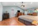 Large main bedroom with wood floors, ceiling fan, and ensuite bathroom access at 9326 Bay Vista Estates Blvd, Orlando, FL 32836