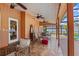 Covered patio area featuring fans, comfortable seating, and access to the pool area at 9326 Bay Vista Estates Blvd, Orlando, FL 32836