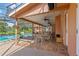 Covered patio featuring tile floors, seating, and a beautiful view of the pool at 9326 Bay Vista Estates Blvd, Orlando, FL 32836