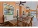 Covered patio featuring tile floors, seating, and easy access to the pool area at 9326 Bay Vista Estates Blvd, Orlando, FL 32836