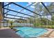Backyard screened-in pool and deck, perfect for relaxation and outdoor entertaining at 9326 Bay Vista Estates Blvd, Orlando, FL 32836