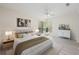 Bright bedroom featuring neutral colors, a ceiling fan, and a large window with blinds at 940 Douglas Ave # 132, Altamonte Springs, FL 32714