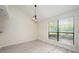 Bright dining area features wood-look floors, modern lighting, and a large window with natural light at 940 Douglas Ave # 132, Altamonte Springs, FL 32714
