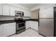 Efficient kitchen with stainless steel appliances, white cabinets, and ample counter space at 940 Douglas Ave # 132, Altamonte Springs, FL 32714