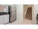 Kitchen area adjacent to carpeted stairs to the second floor at 940 Douglas Ave # 132, Altamonte Springs, FL 32714