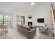 Bright living room with large windows, a fireplace, a ceiling fan, and modern decor at 940 Douglas Ave # 132, Altamonte Springs, FL 32714