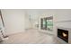 Spacious living room featuring a cozy fireplace and large windows offering peaceful views and natural light at 940 Douglas Ave # 132, Altamonte Springs, FL 32714