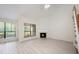 Bright living room features a cozy fireplace and large windows offering peaceful views and natural light at 940 Douglas Ave # 132, Altamonte Springs, FL 32714