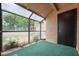 Enclosed sunroom with greenery, offering a tranquil space to relax and enjoy the outdoors at 940 Douglas Ave # 132, Altamonte Springs, FL 32714
