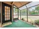 Enclosed sunroom with greenery, offering a tranquil space to relax and enjoy the outdoors at 940 Douglas Ave # 132, Altamonte Springs, FL 32714