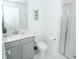 Neat bathroom featuring a single sink with vanity, toilet, and glass shower at 976 Leader St, Davenport, FL 33896