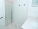 Bright bathroom with a glass shower enclosure and a single sink at 976 Leader St, Davenport, FL 33896