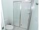 This bathroom features a modern shower stall with glass doors and a white toilet at 976 Leader St, Davenport, FL 33896