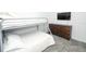 Cozy bedroom featuring a modern bunk bed, gray carpet flooring, and a wooden dresser at 976 Leader St, Davenport, FL 33896
