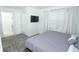 Comfortable bedroom featuring a queen bed, TV, and large window at 976 Leader St, Davenport, FL 33896