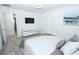 Bright bedroom offers comfortable ambiance, TV, modern dresser and ensuite bathroom access at 976 Leader St, Davenport, FL 33896