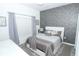 Stylish bedroom showcases a cozy bed with elegant bedding and a unique accent wall at 976 Leader St, Davenport, FL 33896