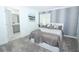 Comfortable bedroom featuring a plush carpet, calming decor, and an ensuite bathroom at 976 Leader St, Davenport, FL 33896
