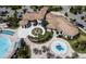 Aerial view showcasing the clubhouse amenities, including a swimming pool and splash pad, perfect for recreation at 976 Leader St, Davenport, FL 33896