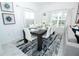 Elegant dining room with a large dark wood table, white chairs, and modern decor at 976 Leader St, Davenport, FL 33896