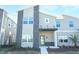 Contemporary townhome with a stylish stone facade, complemented by a lush, landscaped front yard at 976 Leader St, Davenport, FL 33896