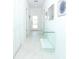 Bright hallway features elegant tile flooring, a glass console table, and stylish wall decor at 976 Leader St, Davenport, FL 33896