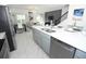 Open-concept kitchen with stainless steel appliances, gray cabinets, white countertops, and seamless flow to the living space at 976 Leader St, Davenport, FL 33896