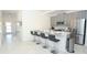 Open kitchen with gray cabinets, stainless steel appliances, and island seating at 976 Leader St, Davenport, FL 33896