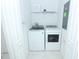 A well-organized laundry room features a modern washer and dryer set, with shelf and tile flooring at 976 Leader St, Davenport, FL 33896