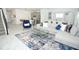 Spacious living area with a gray sofa, blue chair, and stylish decor throughout at 976 Leader St, Davenport, FL 33896