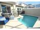 Inviting outdoor pool featuring a safety fence, complemented by comfortable seating and ample space for relaxation at 976 Leader St, Davenport, FL 33896