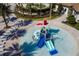 Overhead view of splash pad with slides and water features, ideal for Gathering fun and outdoor activities at 976 Leader St, Davenport, FL 33896