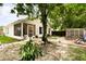 Spacious backyard with mature trees, patio area, and lush greenery at 9814 Piney Point Cir, Orlando, FL 32825