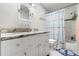 Bright bathroom with a vanity with a granite countertop, a toilet and shower/tub combo with shower curtain at 9814 Piney Point Cir, Orlando, FL 32825